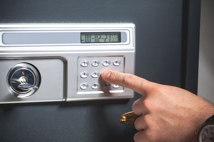 A person carefully opening a safe, focusing on the combination dial and ensuring security measures are followed.