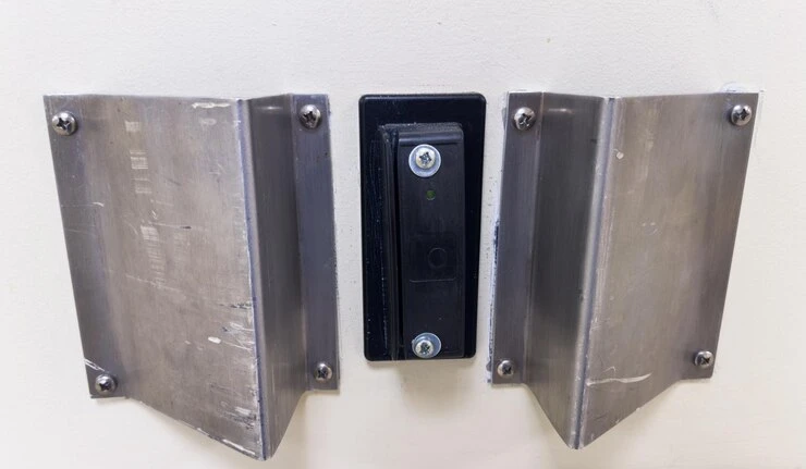 A door featuring two metal plates, labeled as an Electrik Strike