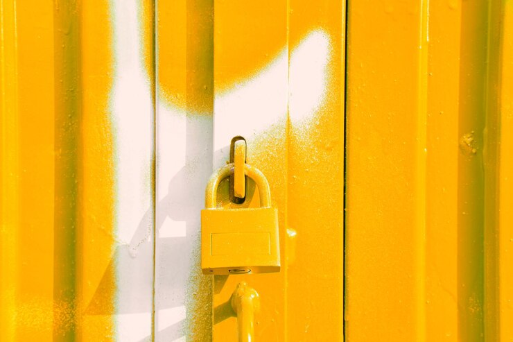 A yellow metal door featuring a padlock, illustrating the gate lock repair services