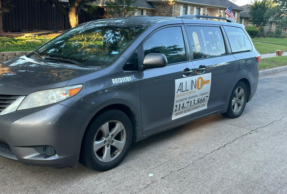 All in 1 Locksmith gray minivan services is parked on a residential street